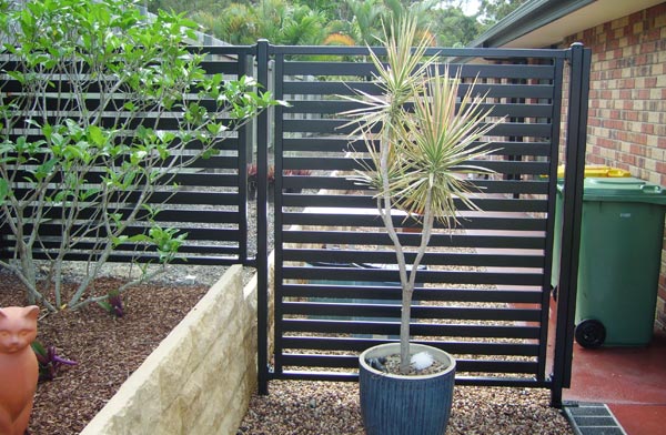 Charcoal horizontal slat privacy screen in a garden