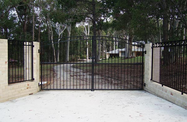 Black aluminium double swing gates across a long driveway